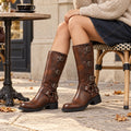 Reddish Brown multi-buckle boots styled with denim and an oatmeal knit
