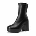 Black sculpted platform ankle boots — single
